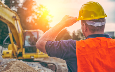 Construction worker on construction site in the heat of the sun 